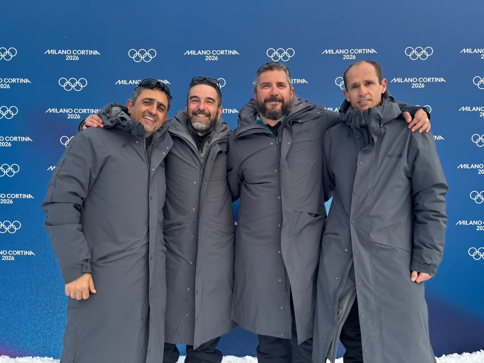 The team in front of the Olympic backdrop